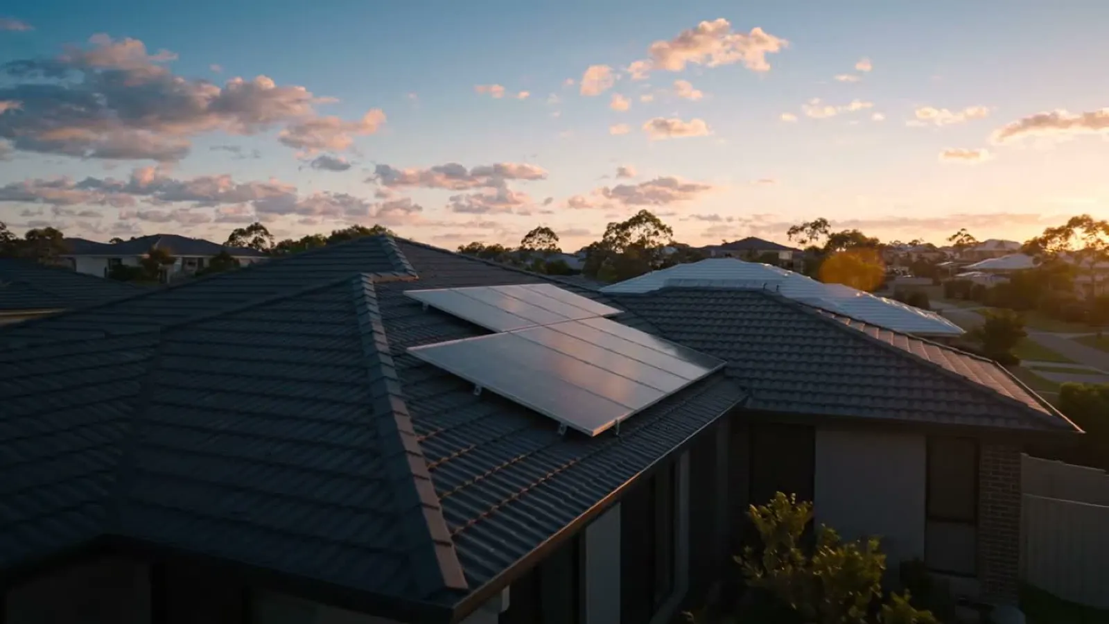 Solar panels on a suburban roof at sunset